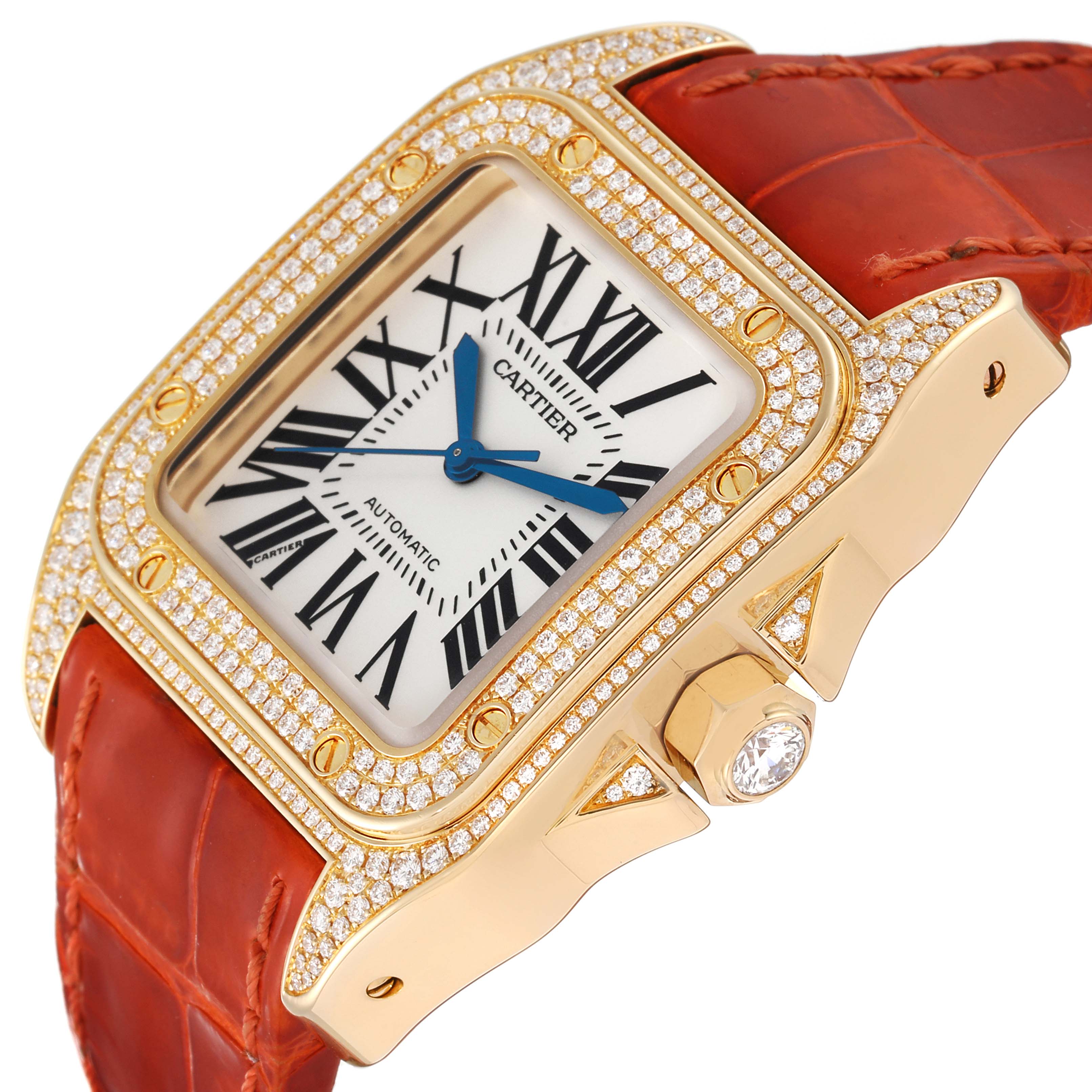 This image shows a close-up angle of the Cartier Santos WM502051 Men
s Yellow Gold Silver Dial WM502051 Men
s Yellow Gold Silver Dial watch, highlighting its diamond-studded bezel, face, and orange leather strap.