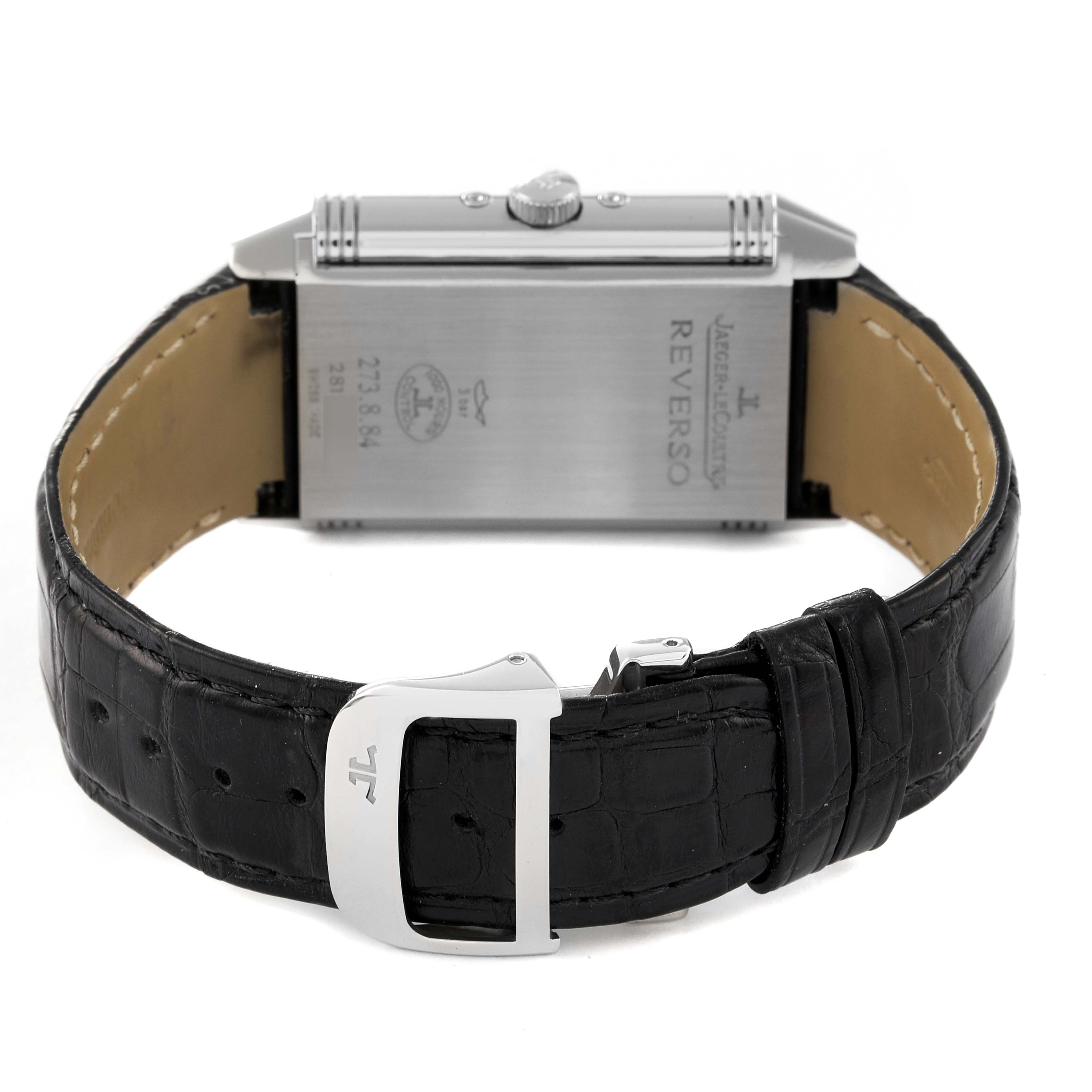 The image shows the back and strap of a Jaeger LeCoultre Reverso Q3758420 Men's Stainless Steel Silver Dial Q3758420 Men's Stainless Steel Silver Dial watch, highlighting the engravings and the black leather strap with the buckle.