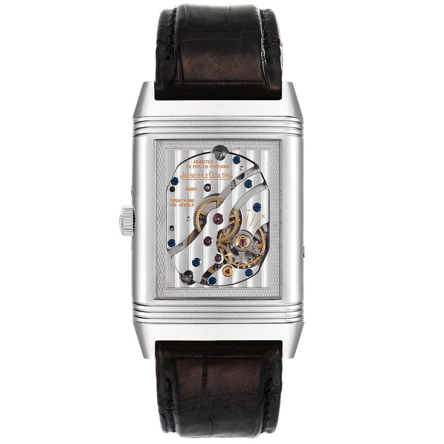 The image shows the back view of a Jaeger-LeCoultre Reverso watch, highlighting the intricate exposed mechanical movement.