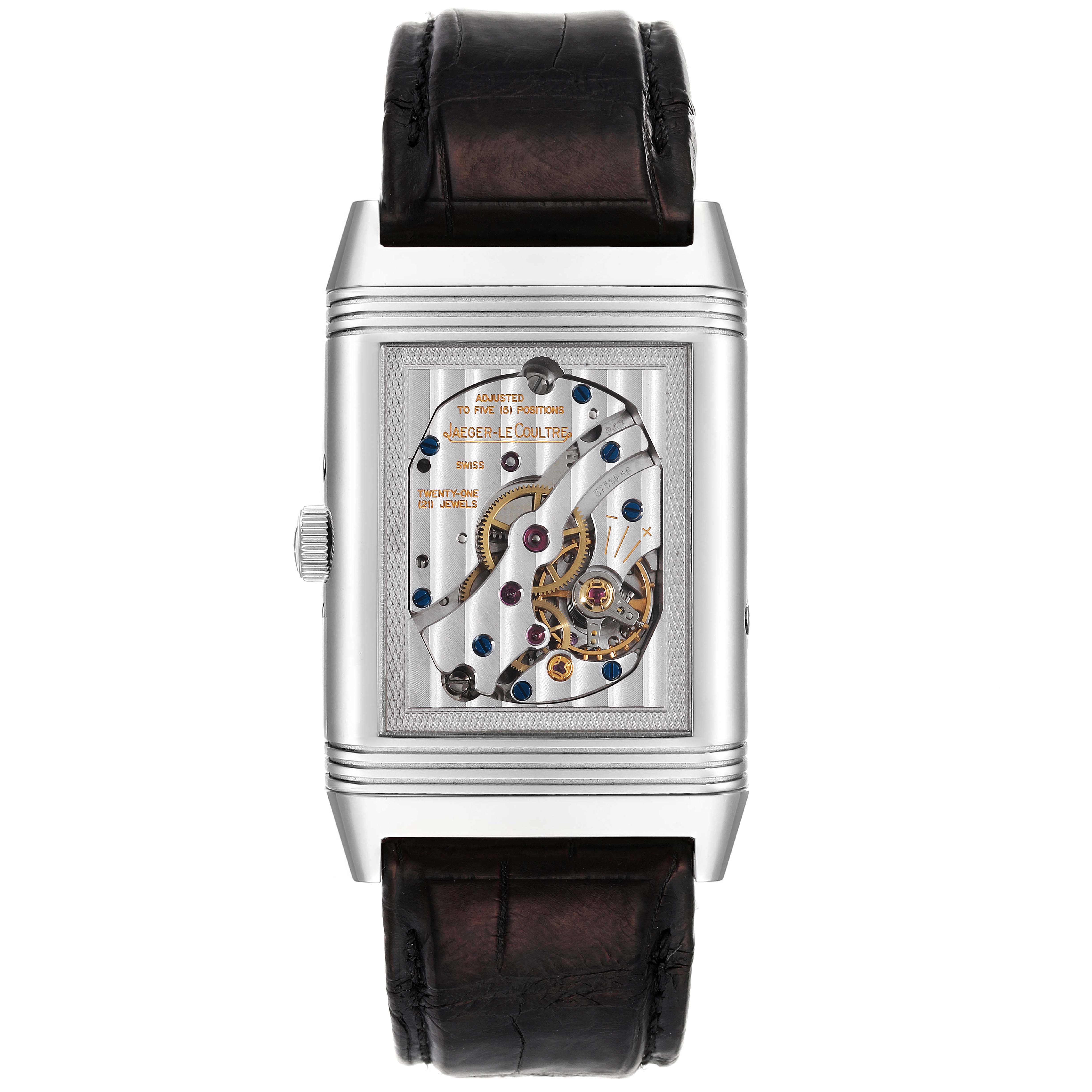 The image shows the back view of a Jaeger-LeCoultre Reverso watch, highlighting the intricate exposed mechanical movement.