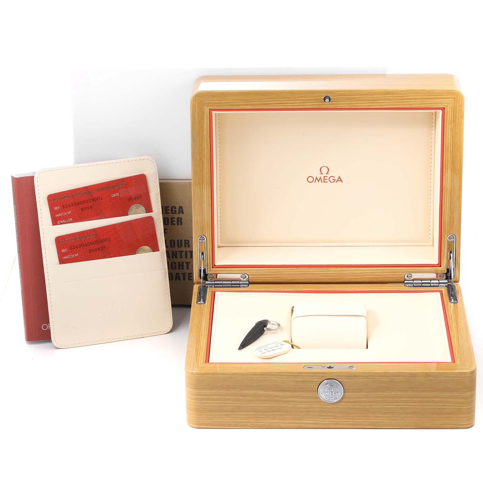 The image shows an open Omega Speedmaster 326.30.40.50.03.001 Men
s Stainless Steel Blue Dial 326.30.40.50.03.001 Men
s Stainless Steel Blue Dial watch box with cards and accessories displayed beside it.