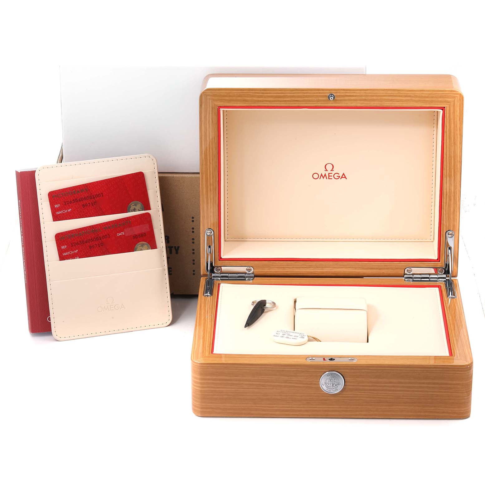 The image shows an open Omega Speedmaster 326.30.40.50.01.002 Men's Stainless Steel Black Dial 326.30.40.50.01.002 Men's Stainless Steel Black Dial watch box with compartments, an instruction booklet, and warranty cards.