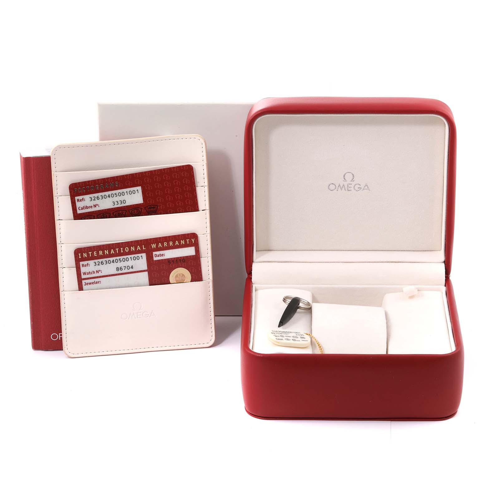 This image shows the Omega Speedmaster 326.30.40.50.01.001 Men's Stainless Steel Black Dial 326.30.40.50.01.001 Men's Stainless Steel Black Dial packaging, an empty watch case, warranty cards, and the manual.