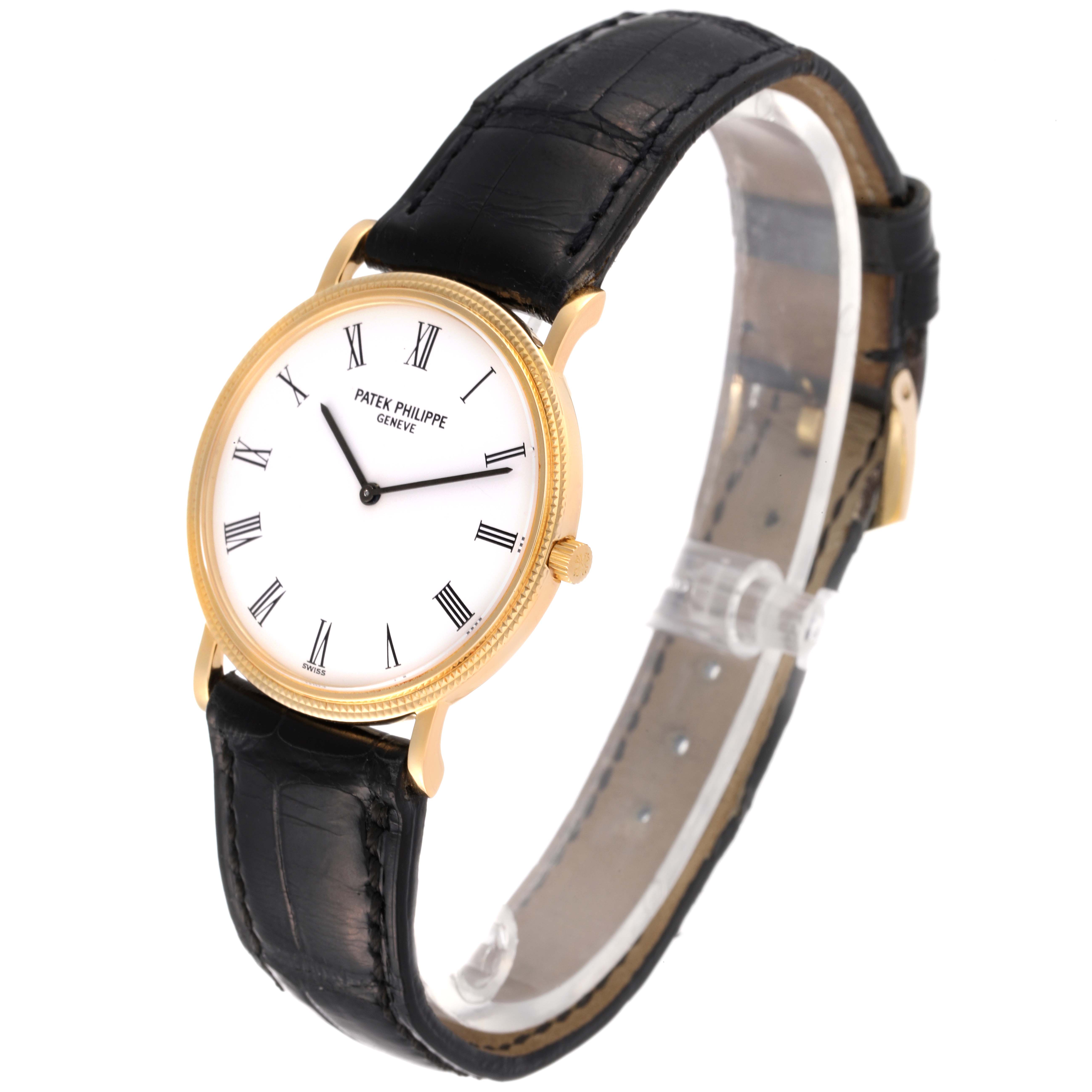 The image shows a side-angle view of a Patek Philippe Calatrava 3520 Men's Yellow Gold White Dial 3520 Men's Yellow Gold White Dial watch, highlighting its gold case, white dial, and black leather strap.