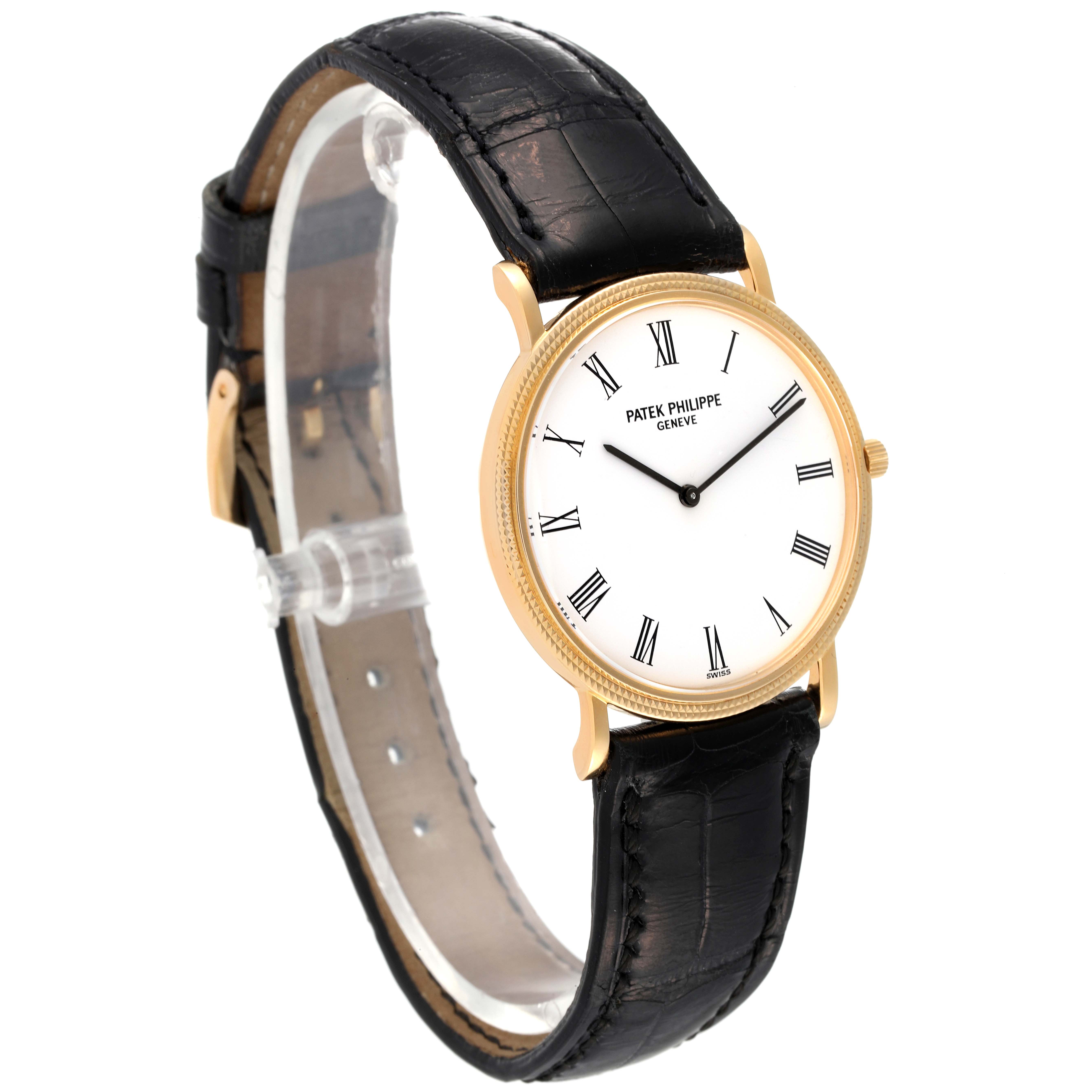 The Patek Philippe Calatrava 3520 Men's Yellow Gold White Dial 3520 Men's Yellow Gold White Dial watch is shown at a slight angle, displaying its face with Roman numerals and black leather strap.