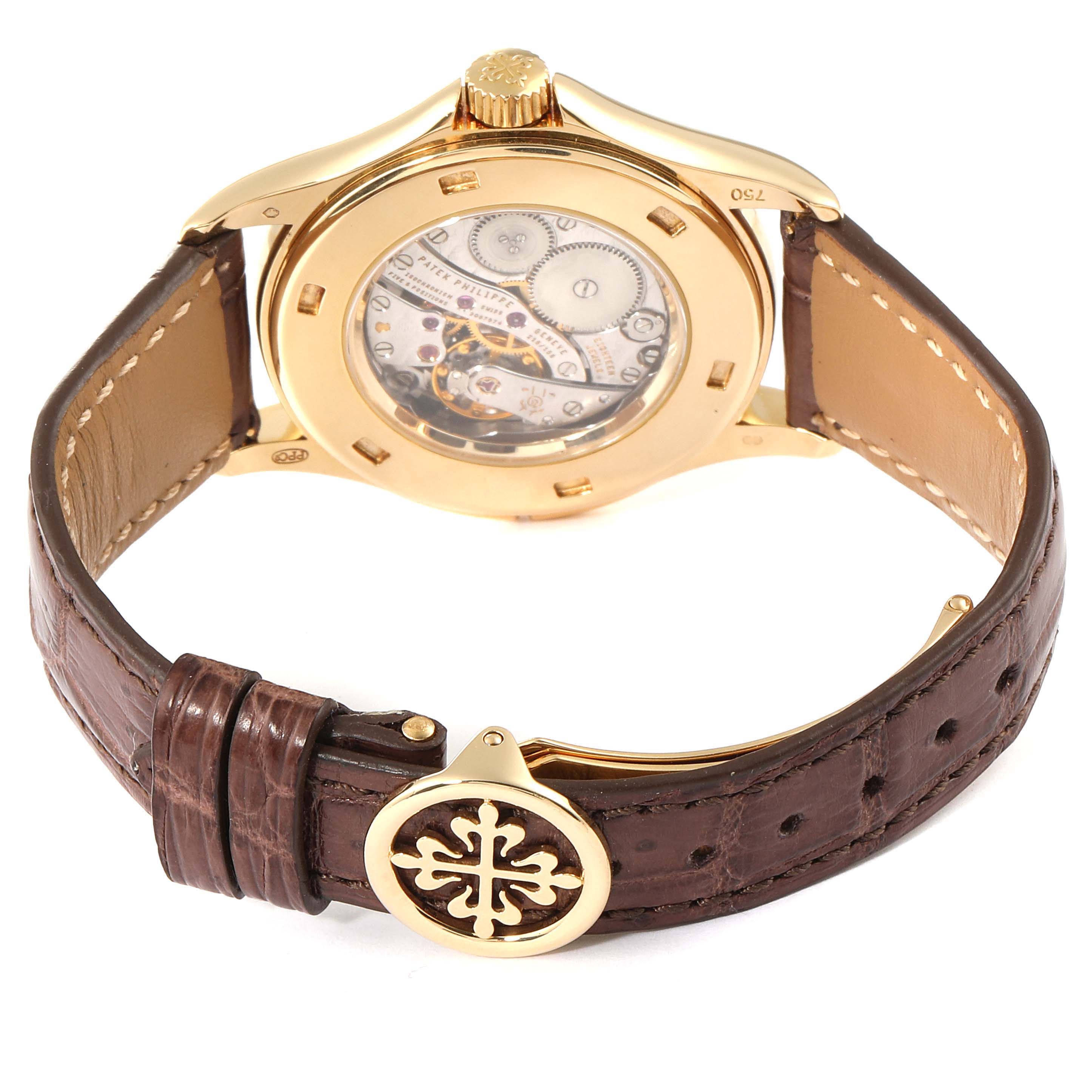 The image shows the back of a Patek Philippe Calatrava 5134J Men
s Yellow Gold White Dial 5134J Men
s Yellow Gold White Dial watch highlighting its mechanical movement and brown leather strap.