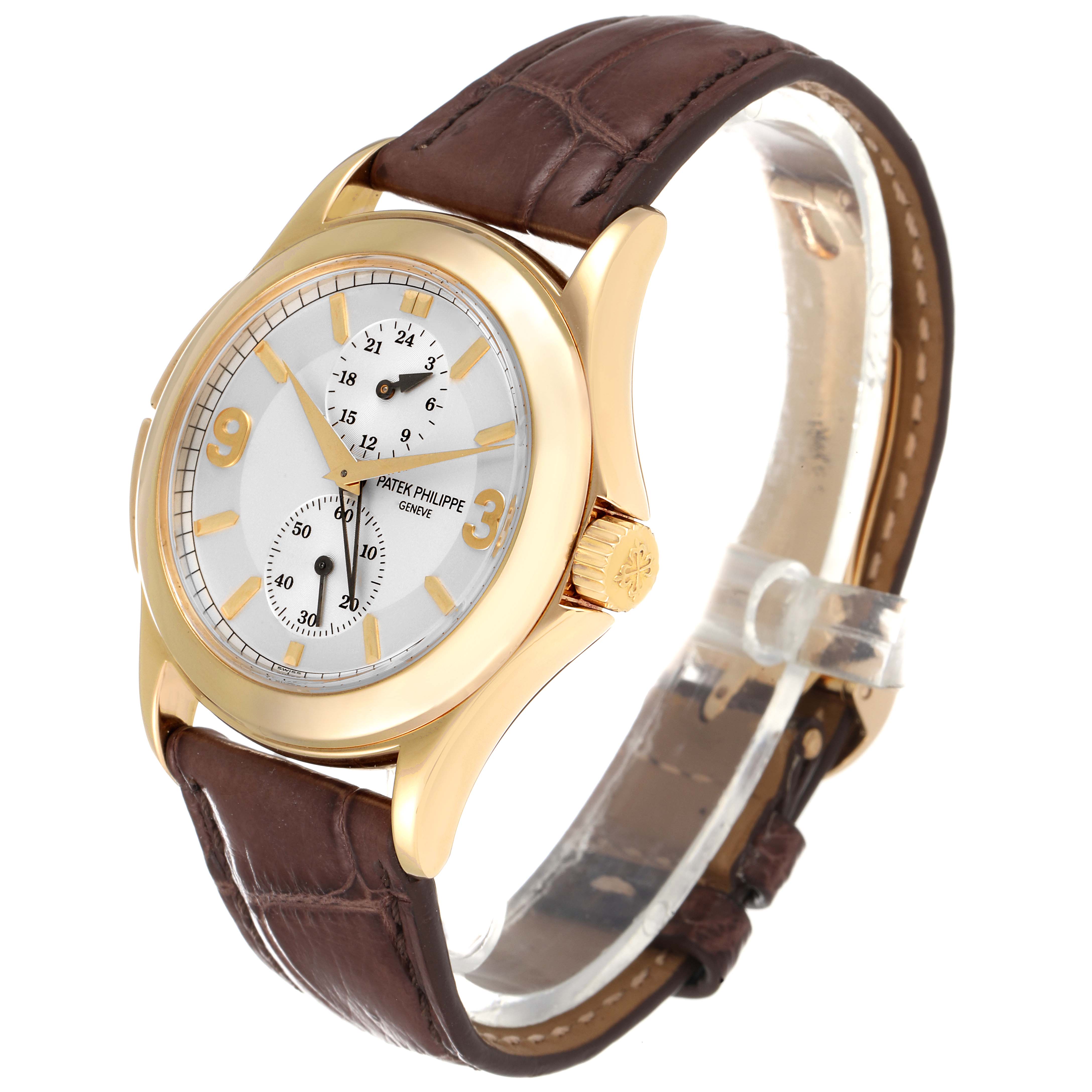 The image shows a side angle of a Patek Philippe Calatrava 5134J Men
s Yellow Gold White Dial 5134J Men
s Yellow Gold White Dial watch, highlighting its brown strap and gold case.