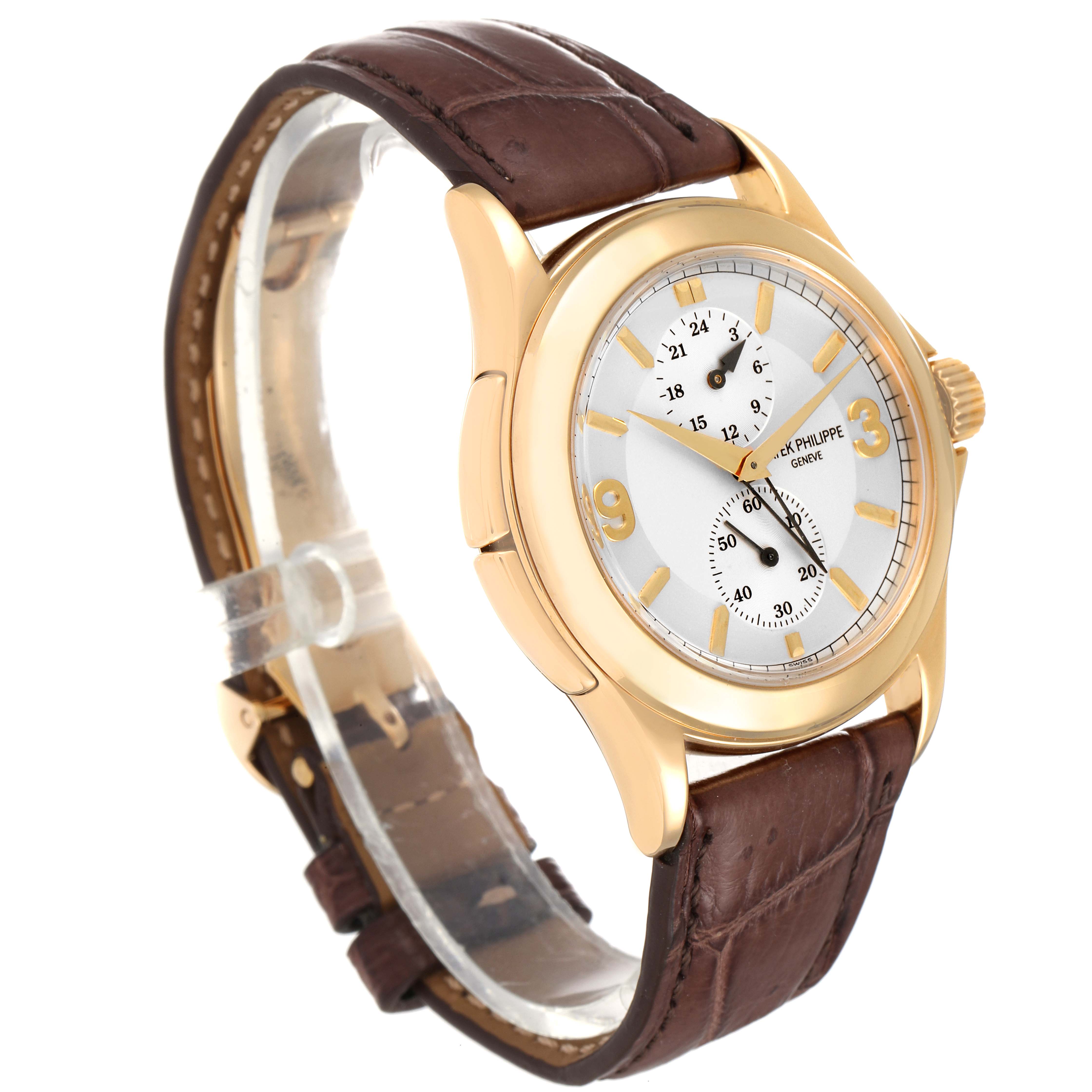 This is a Patek Philippe Calatrava 5134J Men
s Yellow Gold White Dial 5134J Men
s Yellow Gold White Dial watch, shown at a three-quarter angle, showcasing its face, dial, and brown leather strap.