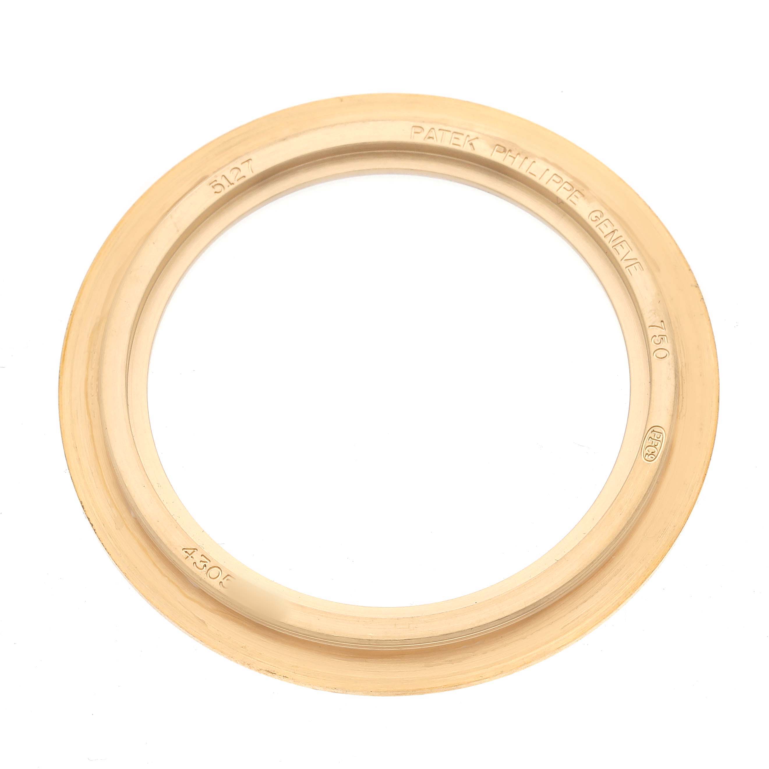 The image shows a gold-toned bezel from a Patek Philippe Calatrava 5107J Men's Yellow Gold Silver Dial watch, viewed from above.