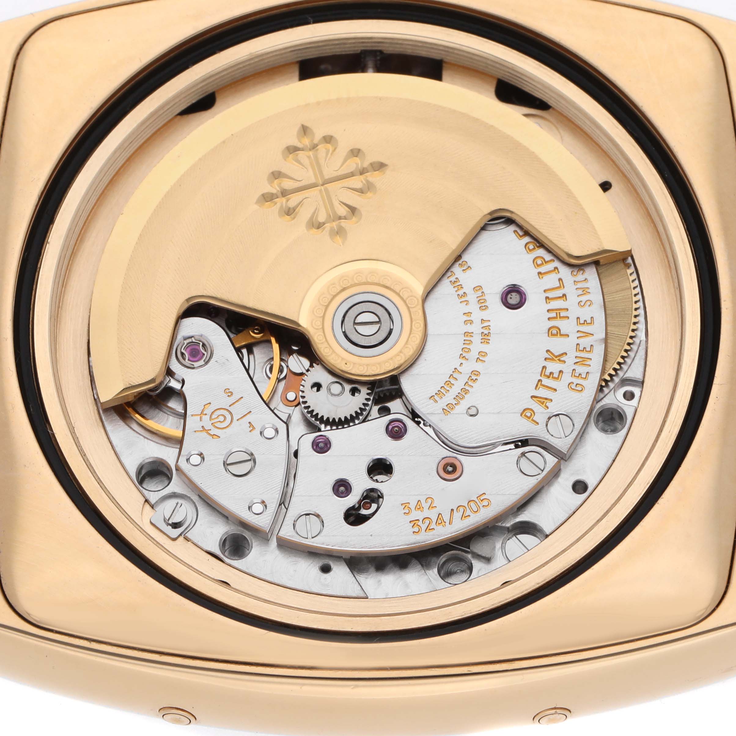 The image shows the open case back of a Patek Philippe Gondolo 5135J Men's Yellow Gold White Dial, highlighting its mechanical movement.