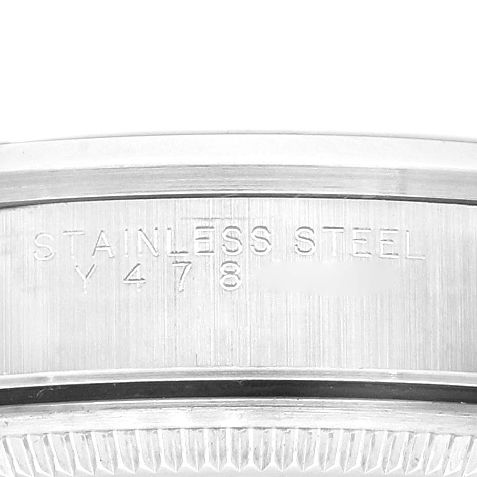 This image shows a close-up of the engraved edge of the stainless steel case back of a Rolex Air-King 14000M Men's Stainless Steel Black Dial 14000M Men's Stainless Steel Black Dial watch.