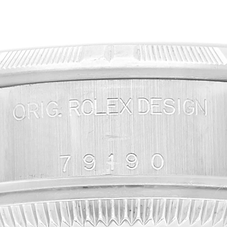 The image shows the engraved side view of a Rolex Date 79190 Women
s Stainless Steel Pink Dial 79190 Women
s Stainless Steel Pink Dial model watch case displaying "ORIG. ROLEX DESIGN 79190."