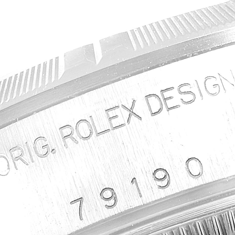 This image shows a close-up of the bezel and casing of a Rolex Date 79190 Women's Stainless Steel Pink Dial 79190 Women's Stainless Steel Pink Dial model watch, displaying the engraving.