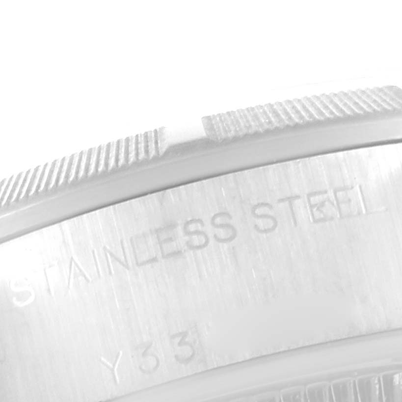 The image shows a close-up of the side engraving on a Rolex Date 79190 Women's Stainless Steel Pink Dial 79190 Women's Stainless Steel Pink Dial model watch, highlighting the stainless steel material.