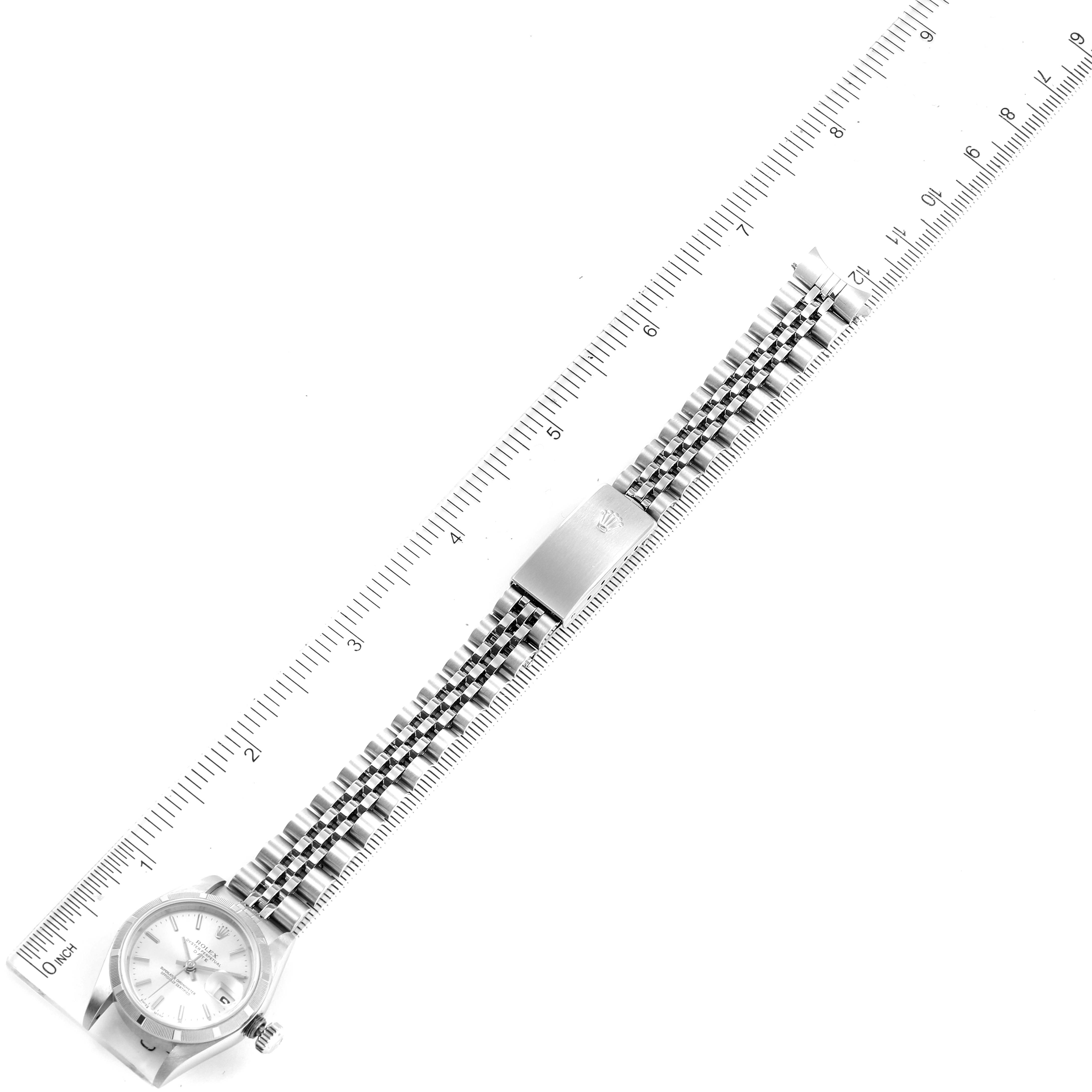 The image shows a top-down view of a Rolex Date 79190 Women's Stainless Steel Silver Dial 79190 Women's Stainless Steel Silver Dial model watch with a stainless steel bracelet, beside a ruler for scale.