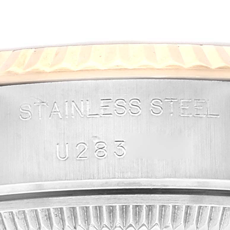 This close-up shows the side of the stainless steel case back of a Rolex Datejust 69173 Women's Steel and Gold (two tone) Champagne Dial 69173 Women's Steel and Gold (two tone) Champagne Dial watch with serial number engraving.