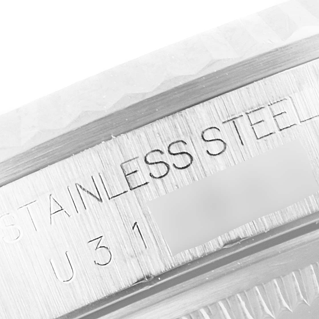 The image shows a close-up angle of the Rolex Datejust 16234 Men's Stainless Steel Pink Dial 16234 Men's Stainless Steel Pink Dial watch case, highlighting the "STAINLESS STEEL" engraving.