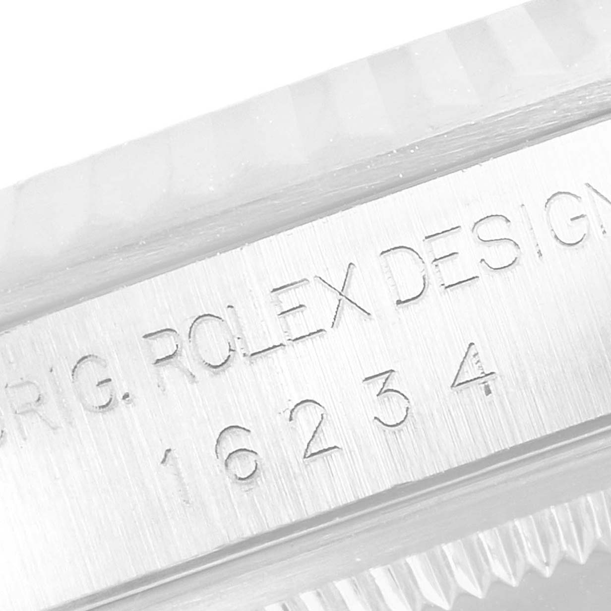 The image shows an embossed engraving of the model number "16234" and "ROLEX DESIGN" on the case side of the Rolex Datejust 16234 Men's Stainless Steel Pink Dial 16234 Men's Stainless Steel Pink Dial watch.