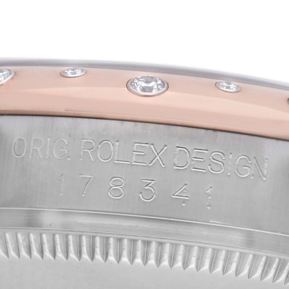 The image shows a side-view of a Rolex Mid-Size 178341 Women's Steel and Gold (two tone) Brown Dial watch, focusing on the bezel with diamonds and engraved serial number.