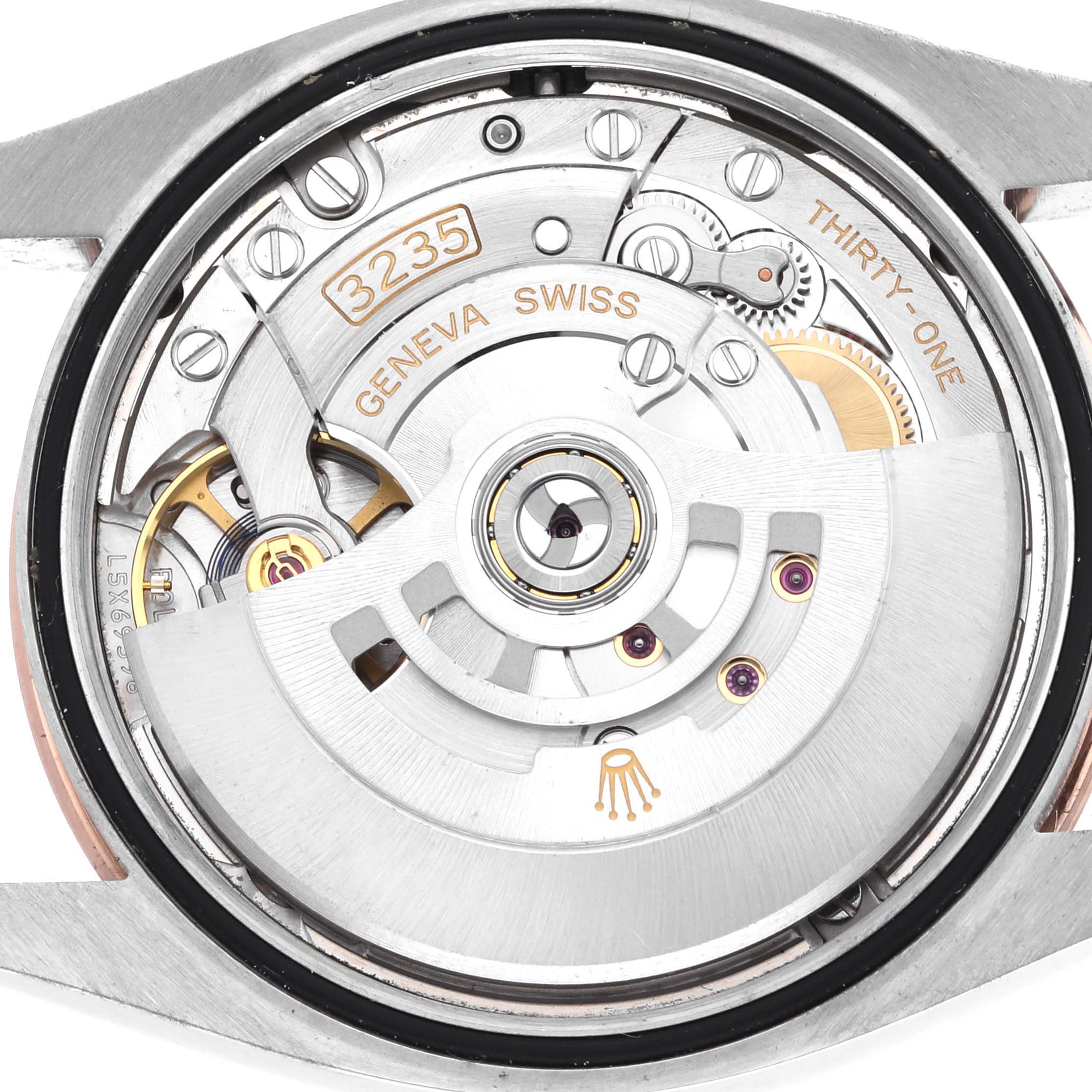 The image shows a close-up of the Rolex Datejust 126231 Men's Steel and Gold (two tone) Mother of Pearl Dial movement, displaying intricate gears and markings from a rear angle.