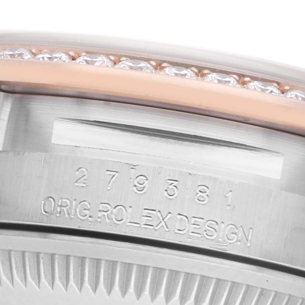 The image shows a close-up of the side of a Rolex Datejust 279381 Women's Steel and Gold (two tone) Mother of Pearl Dial watch, highlighting the bezel with diamonds and engraved serial details.