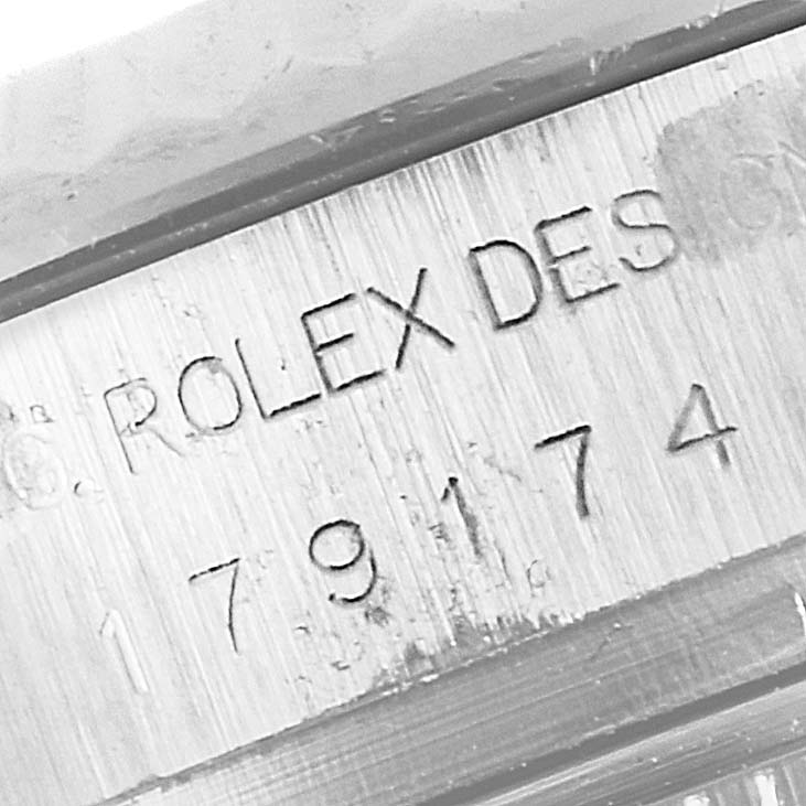 The image shows a close-up of the engraved serial number and "ROLEX DESIGN" text on the case side of a Rolex Datejust 179174 Women
s Stainless Steel Mother of Pearl Dial 179174 Women
s Stainless Steel Mother of Pearl Dial watch.