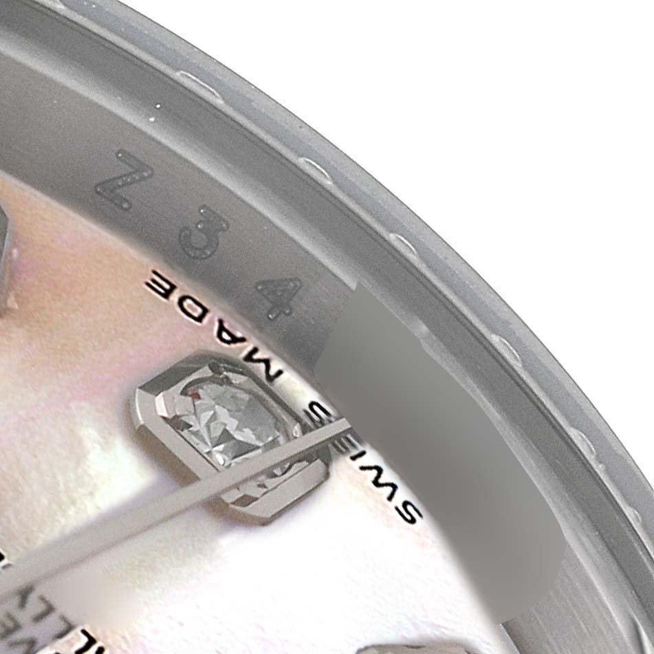 This close-up image of a Rolex Datejust 179174 Women
s Stainless Steel Mother of Pearl Dial 179174 Women
s Stainless Steel Mother of Pearl Dial watch showcases a part of the dial with diamond hour markers and "Swiss Made" text.