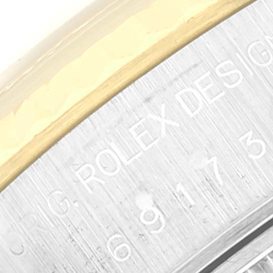 The image shows a close-up of the edge and engraved serial number on a Rolex Datejust 69173 Women's Steel and Gold (two tone) Champagne Dial 69173 Women's Steel and Gold (two tone) Champagne Dial model.