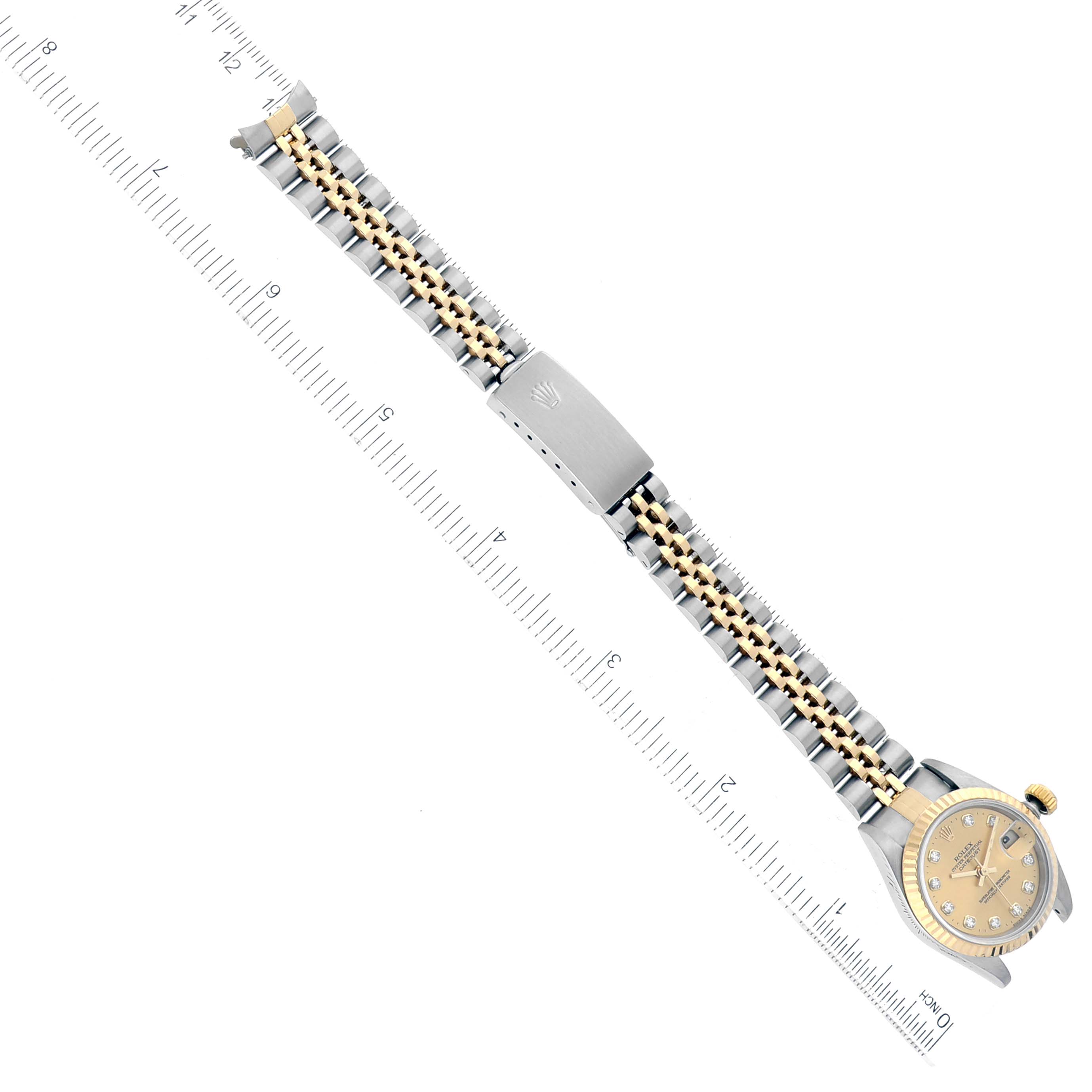 The image shows a top-down view of a Rolex Datejust 69173 Women's Steel and Gold (two tone) Champagne Dial 69173 Women's Steel and Gold (two tone) Champagne Dial watch with its bracelet extended and a ruler for scale.