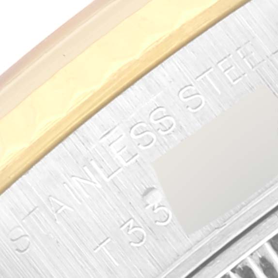 Close-up of the edge of a Rolex Datejust 69173 Women's Steel and Gold (two tone) Champagne Dial 69173 Women's Steel and Gold (two tone) Champagne Dial showing the stainless steel text and part of the bezel.