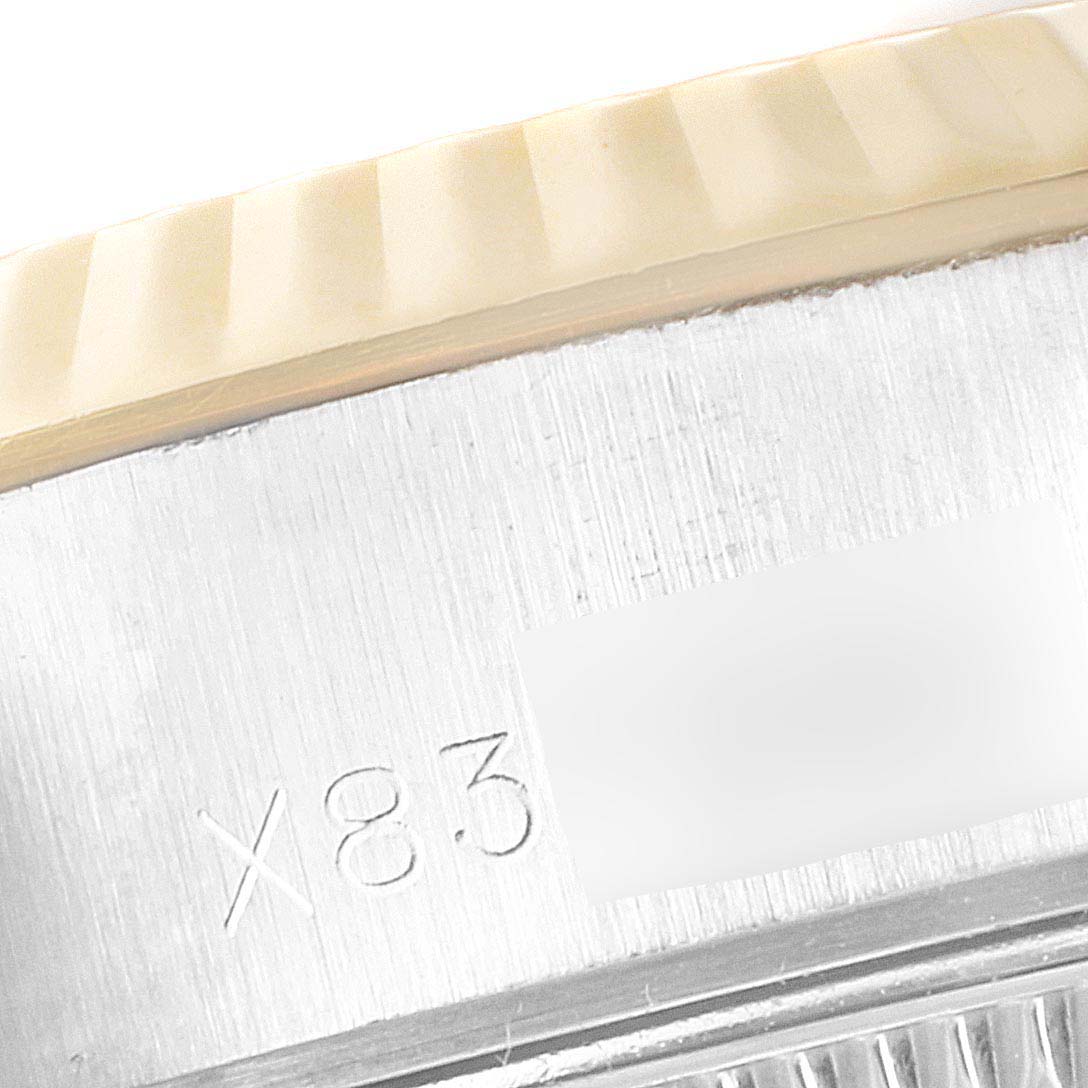 This image shows a close-up of the serial number engraving and the fluted bezel of a Rolex Datejust 69173 Women's Steel and Gold (two tone) Champagne Dial 69173 Women's Steel and Gold (two tone) Champagne Dial watch.