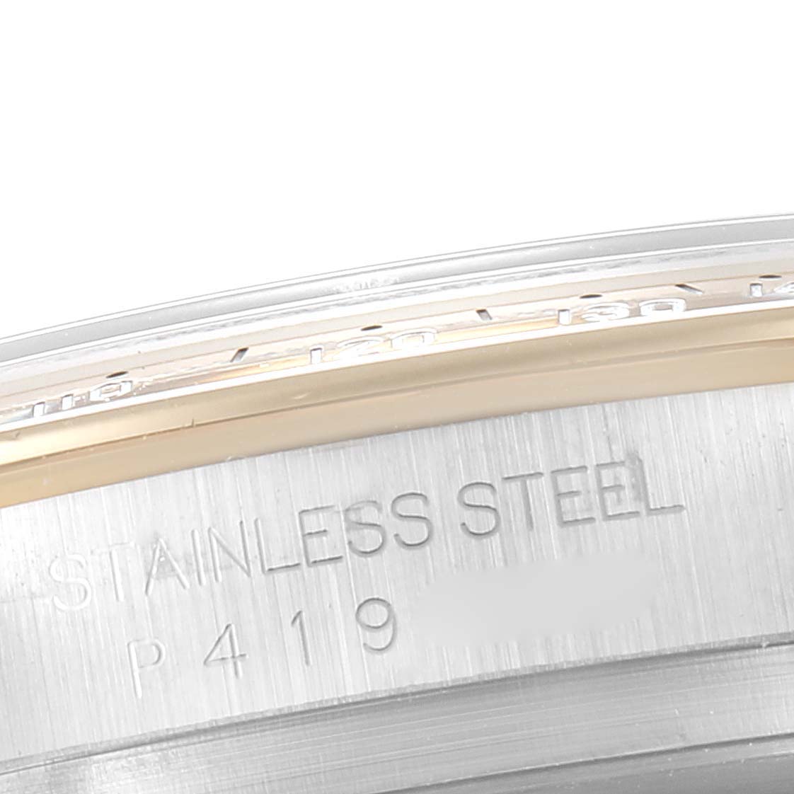 The image shows a close-up of the side and part of the bezel of a Rolex Daytona 116523 Men's Steel and Gold (two tone) Champagne Dial 116523 Men's Steel and Gold (two tone) Champagne Dial watch, highlighting the "Stainless Steel" engraving.