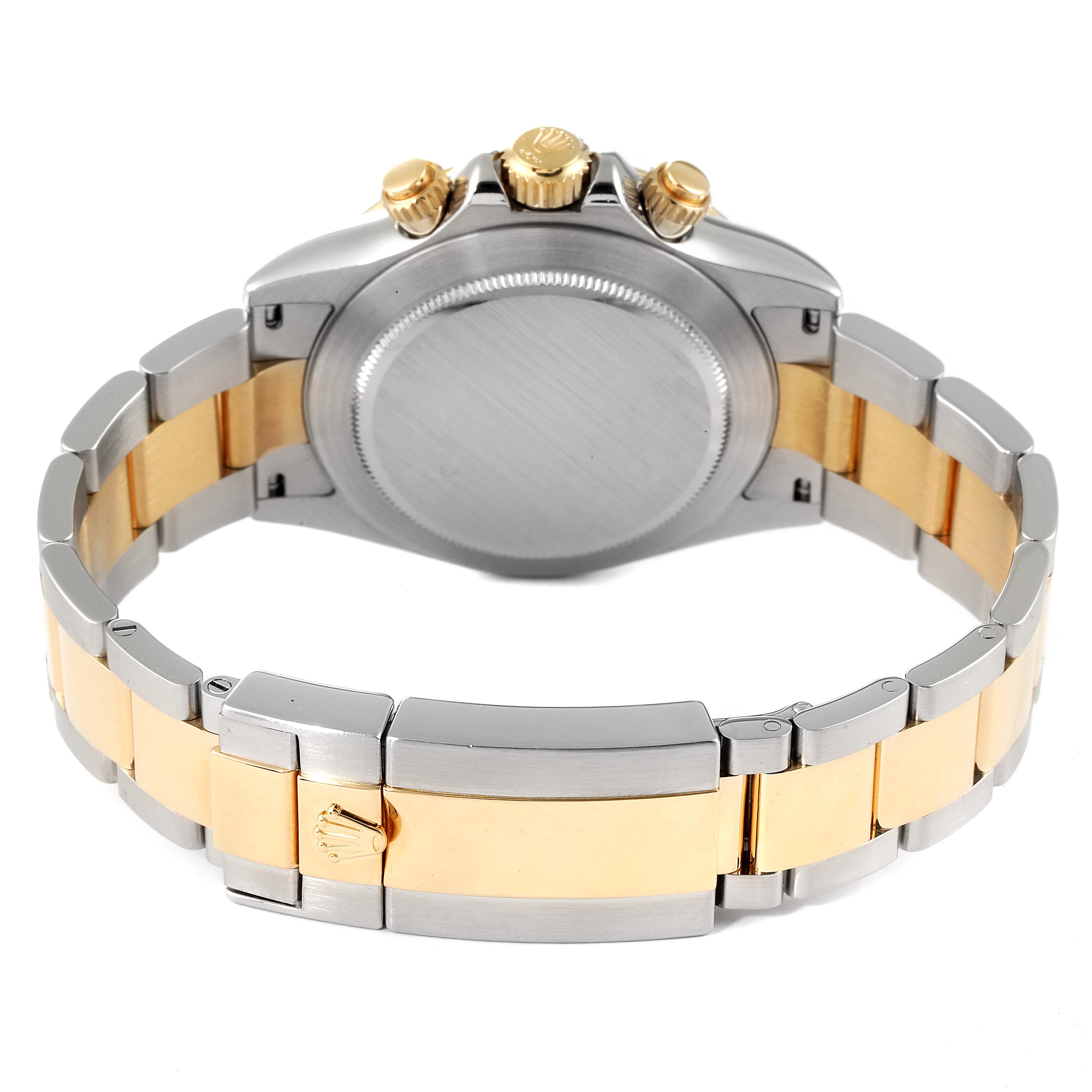 The image shows the back of a Rolex Daytona 116523 Men
s Steel and Gold (two tone) Black Dial 116523 Men
s Steel and Gold (two tone) Black Dial watch, highlighting the case back, crown, pushers, and two-tone bracelet.