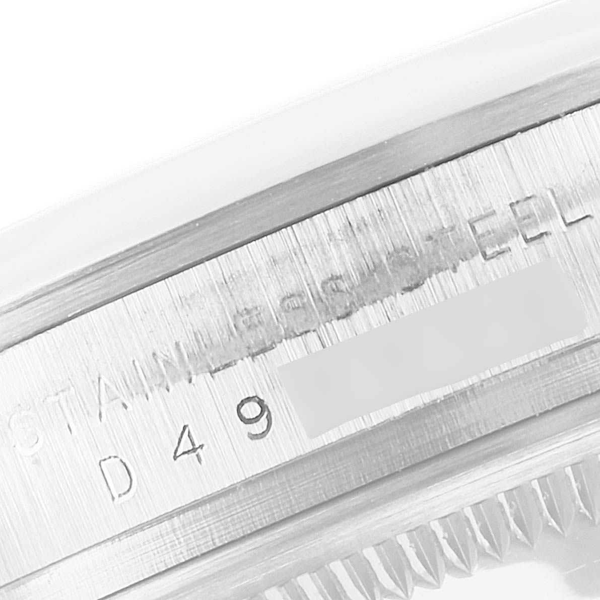 This close-up shows the stainless steel case with inscriptions and part of the bezel edge of the Rolex Explorer 114270 Men's Stainless Steel Black Dial 114270 Men's Stainless Steel Black Dial watch.