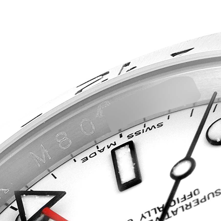 This close-up image of a Rolex Explorer 16570 Men
s Stainless Steel White Dial 16570 Men
s Stainless Steel White Dial watch shows part of the dial, hands, and the inner rim with engraved markings.