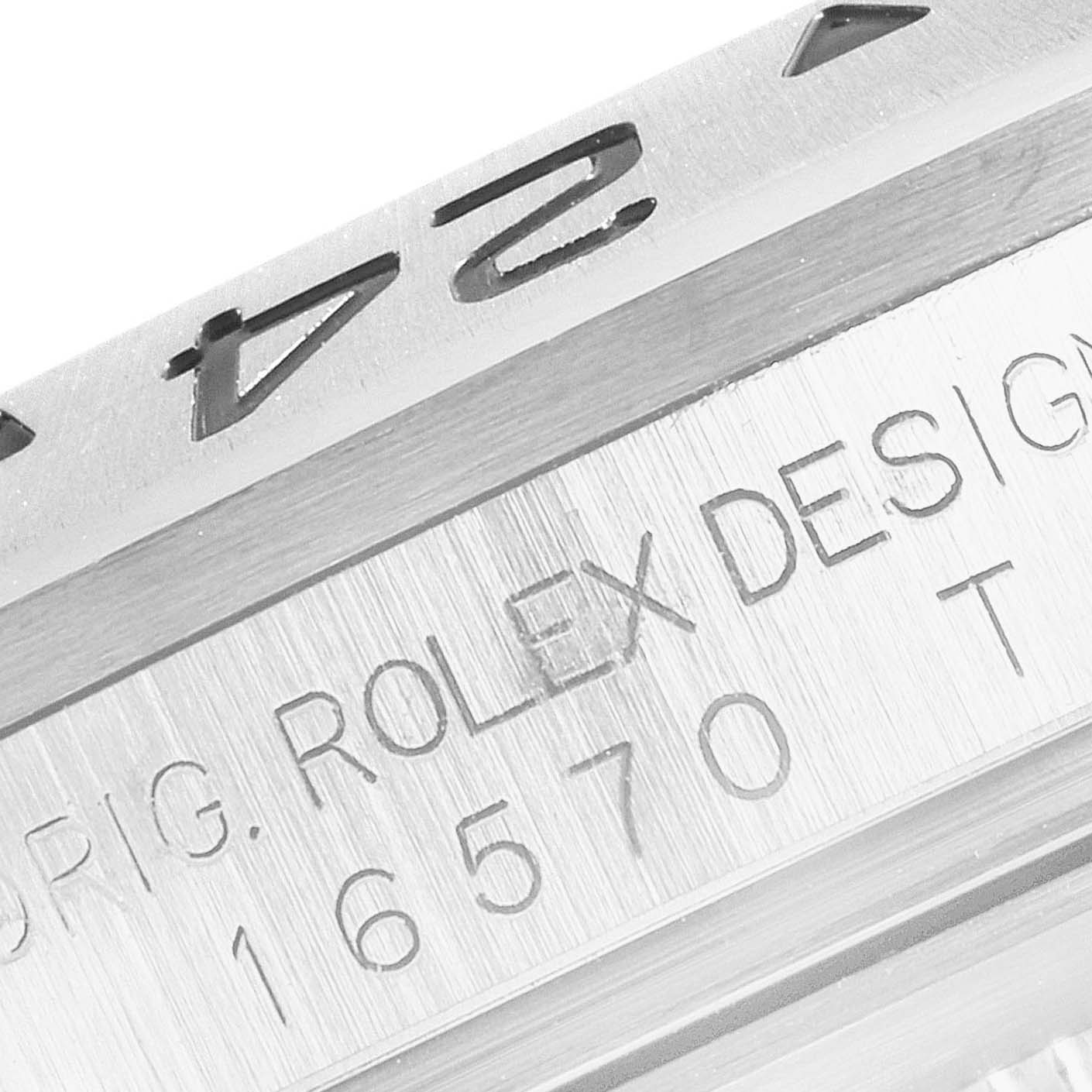 This image shows a close-up of the bezel and case of a Rolex Explorer 16570 Men
s Stainless Steel White Dial 16570 Men
s Stainless Steel White Dial watch, highlighting the engraved text.