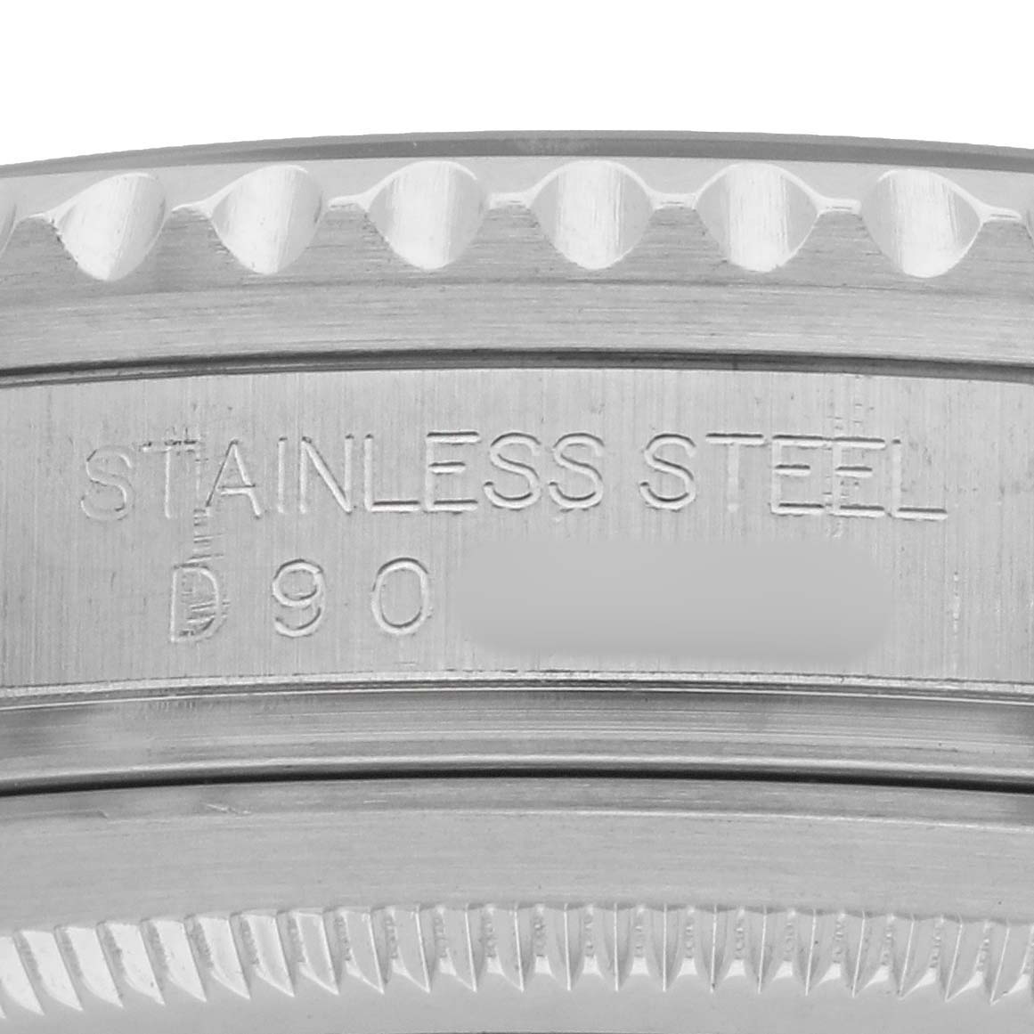 The image shows a close-up of the case side of a Rolex GMT-Master 16710 Men's Stainless Steel Black Dial, focusing on the stainless steel engraving.