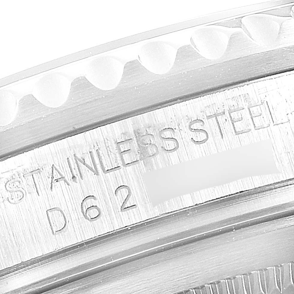 The image shows a close-up of the side of a Rolex GMT-Master 16710 Men
s Stainless Steel Black Dial 16710 Men
s Stainless Steel Black Dial watch, highlighting the engraved "STAINLESS STEEL" text and some serial numbers.