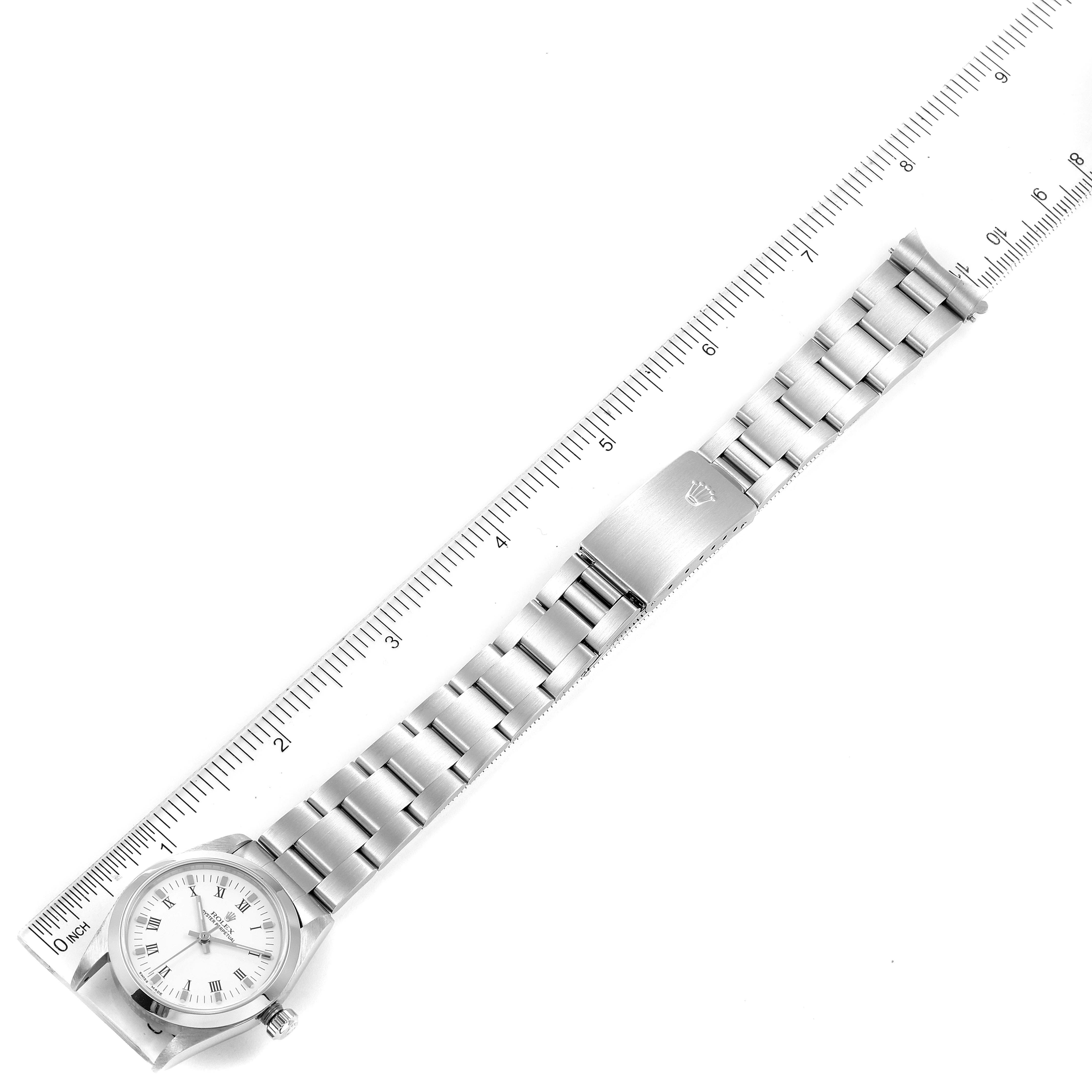 The image shows a Rolex Mid-Size 77080 Women
s Stainless Steel White Dial 77080 Women
s Stainless Steel White Dial watch laying flat, with a ruler measuring its band length.
