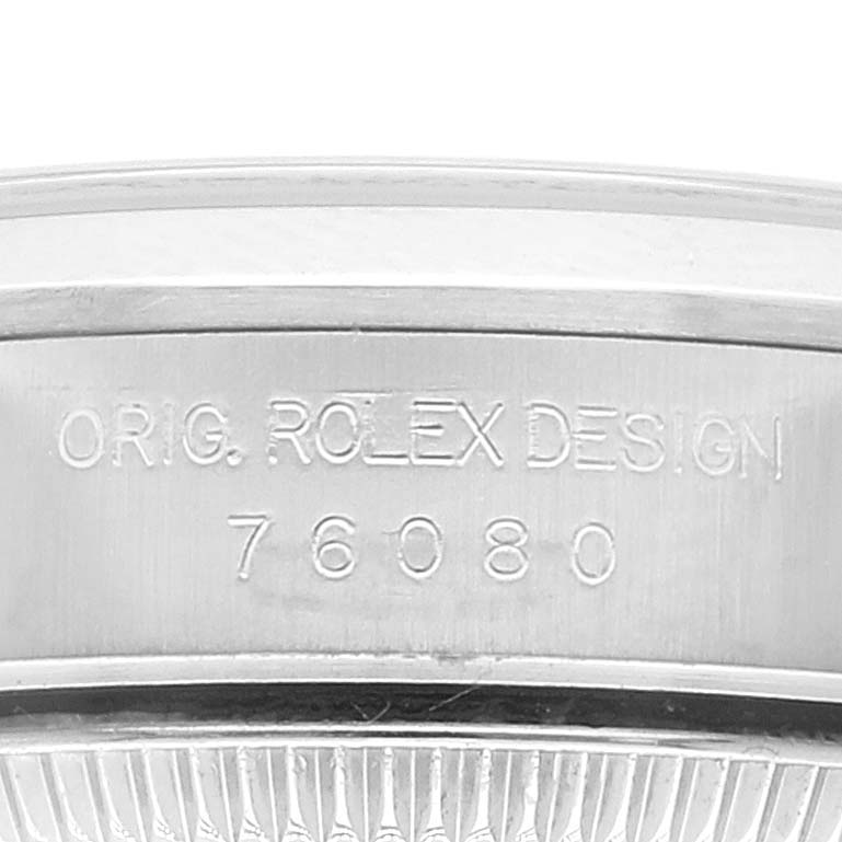 This is a close-up view of the casing of a Rolex Oyster Perpetual 76080 Women
s Stainless Steel Pink Dial 76080 Women
s Stainless Steel Pink Dial watch, showing design details and model number 76080.