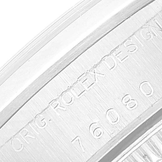 The image shows an angled close-up of the engraved serial number on the casing of a Rolex Oyster Perpetual 76080 Women
s Stainless Steel Pink Dial 76080 Women
s Stainless Steel Pink Dial watch.