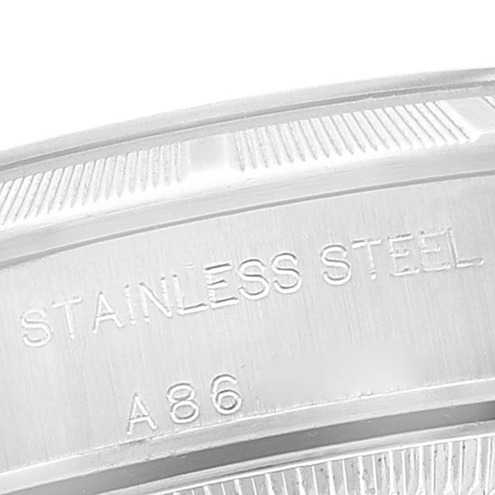 The image shows a close-up of the inner case back of a Rolex Oyster Perpetual 76030 Women
s Stainless Steel Pink Dial 76030 Women
s Stainless Steel Pink Dial watch with "STAINLESS STEEL" and "A86" engravings visible.