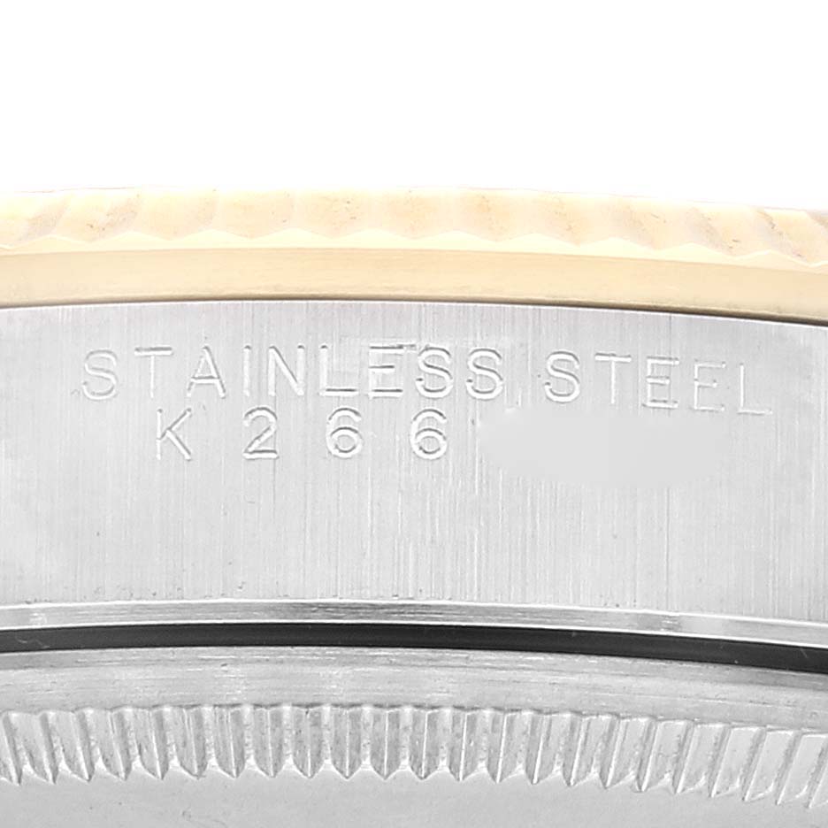 This is a close-up of the case side of a Rolex Oyster Perpetual 14233 Men's Steel and Gold (two tone) Black Dial 14233 Men's Steel and Gold (two tone) Black Dial watch, showing the "STAINLESS STEEL" engraving.