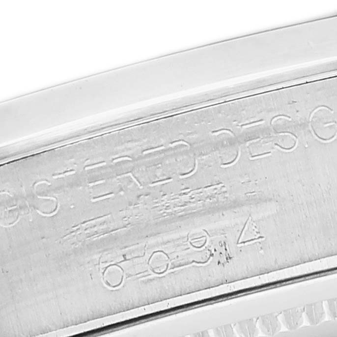 This image shows a close-up of the Rolex Vintage Collection 6694 Men's Stainless Steel Blue Dial 6694 Men's Stainless Steel Blue Dial model, focusing on the engraved serial number and part of the case.