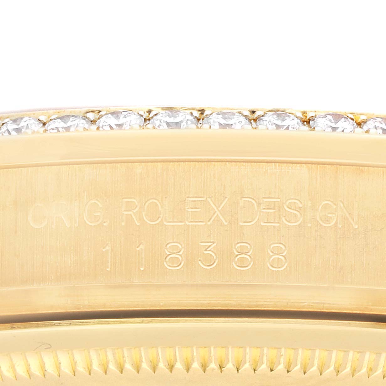 The image shows a close-up side view of the case edge and part of the diamond bezel, with engravings on the Rolex President 118388 Men's Yellow Gold Green Dial model.