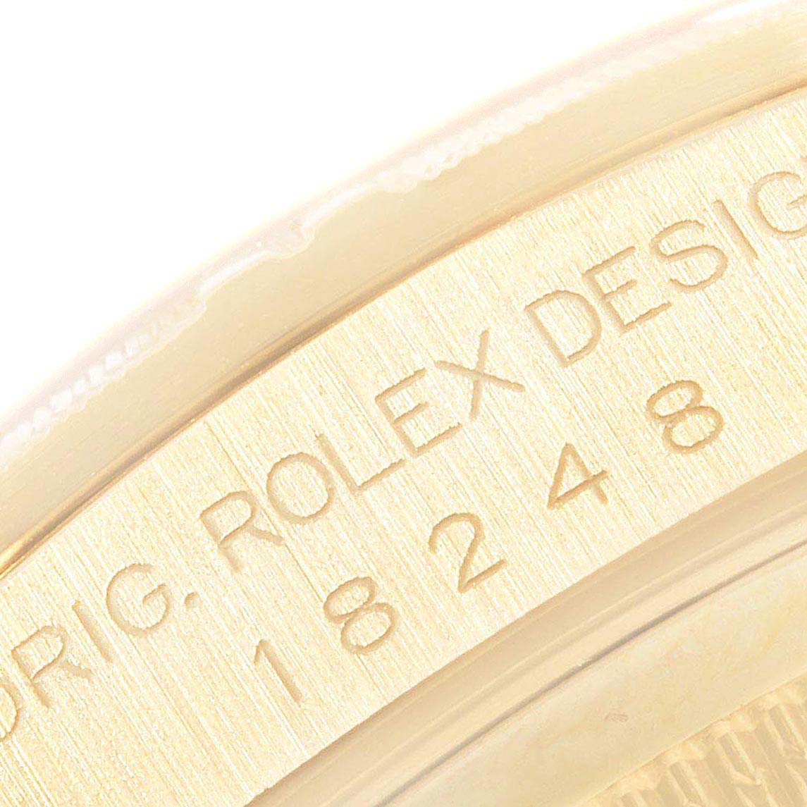This image shows a close-up of the engraving on the side of a Rolex President 18248 Men's Yellow Gold Champagne Dial 18248 Men's Yellow Gold Champagne Dial model watch.