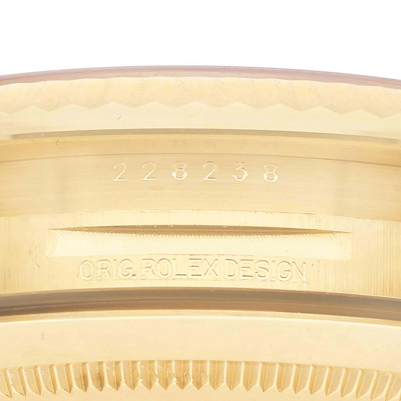 The image shows a close-up of the side engravings on the case of a Rolex President 228238 Men's Yellow Gold Champagne Dial watch.