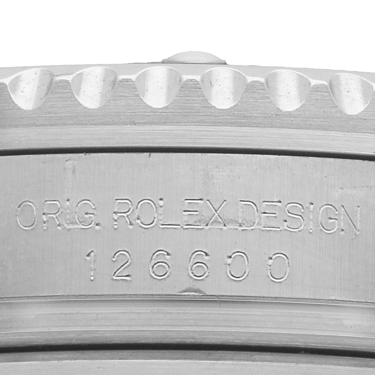 The image shows a close-up of the side of a Rolex Sea-Dweller 126600 Men's Stainless Steel Black Dial, highlighting the engraved design number "126600."