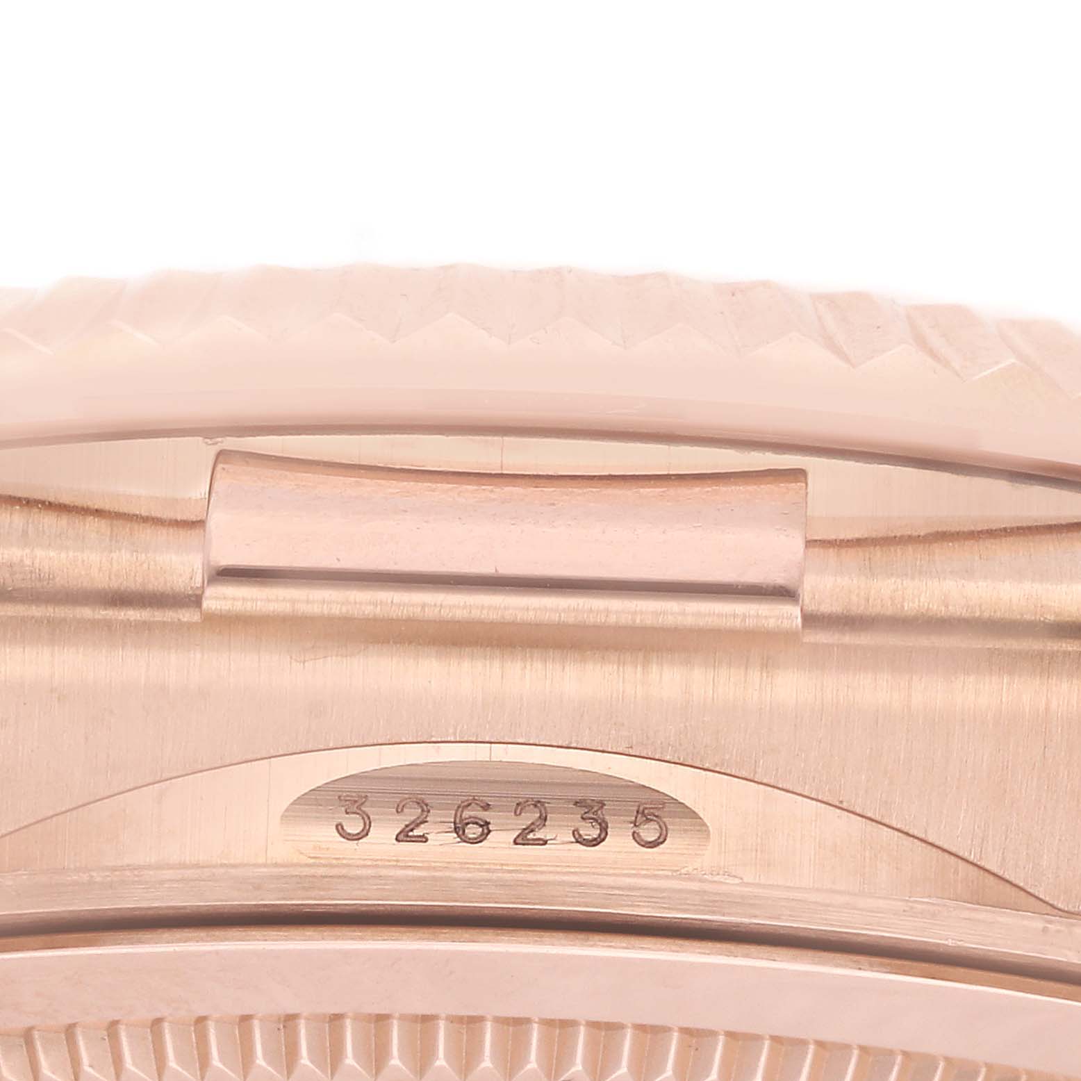 The image shows a close-up of the Rolex Sky-Dweller 326235 Men's Rose Gold Brown Dial's case with a focus on the bracelet attachment and serial number.