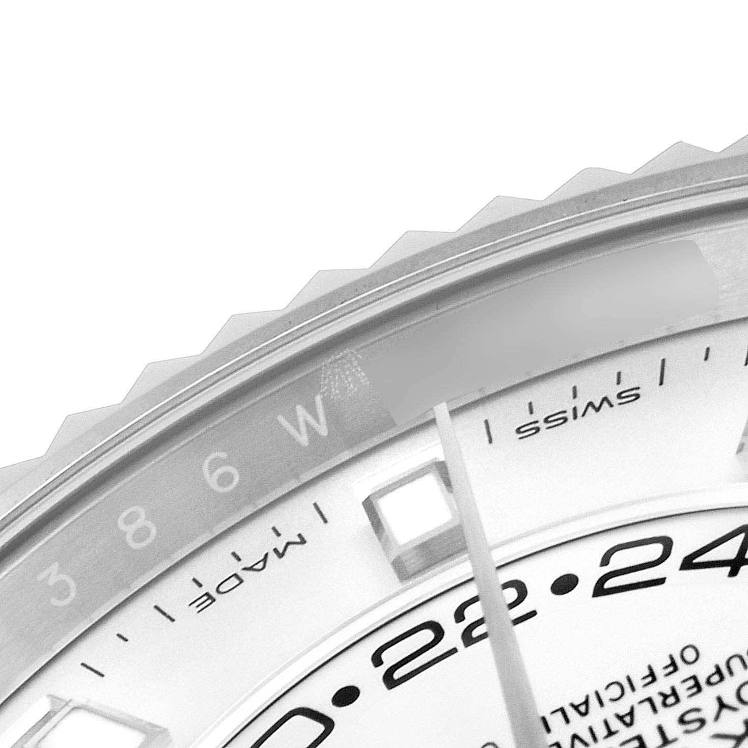 This is a close-up of the Rolex Sky-Dweller 326934 Men's Stainless Steel White Dial 326934 Men's Stainless Steel White Dial watch's dial and bezel showing part of the hour marker and the "SWISS MADE" text.